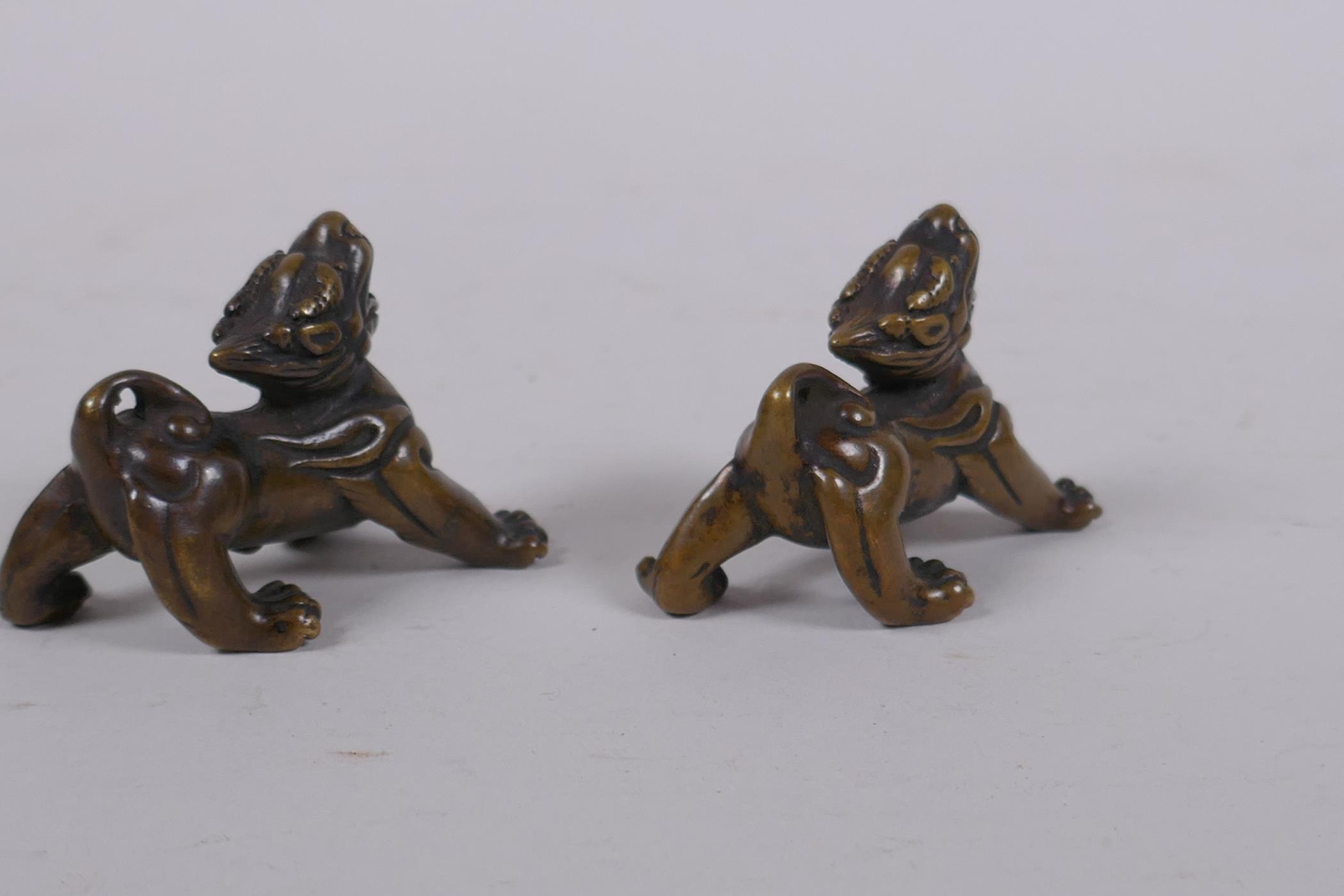 A pair of Chinese bronze kylin scroll weights, 5cm long - Image 3 of 4