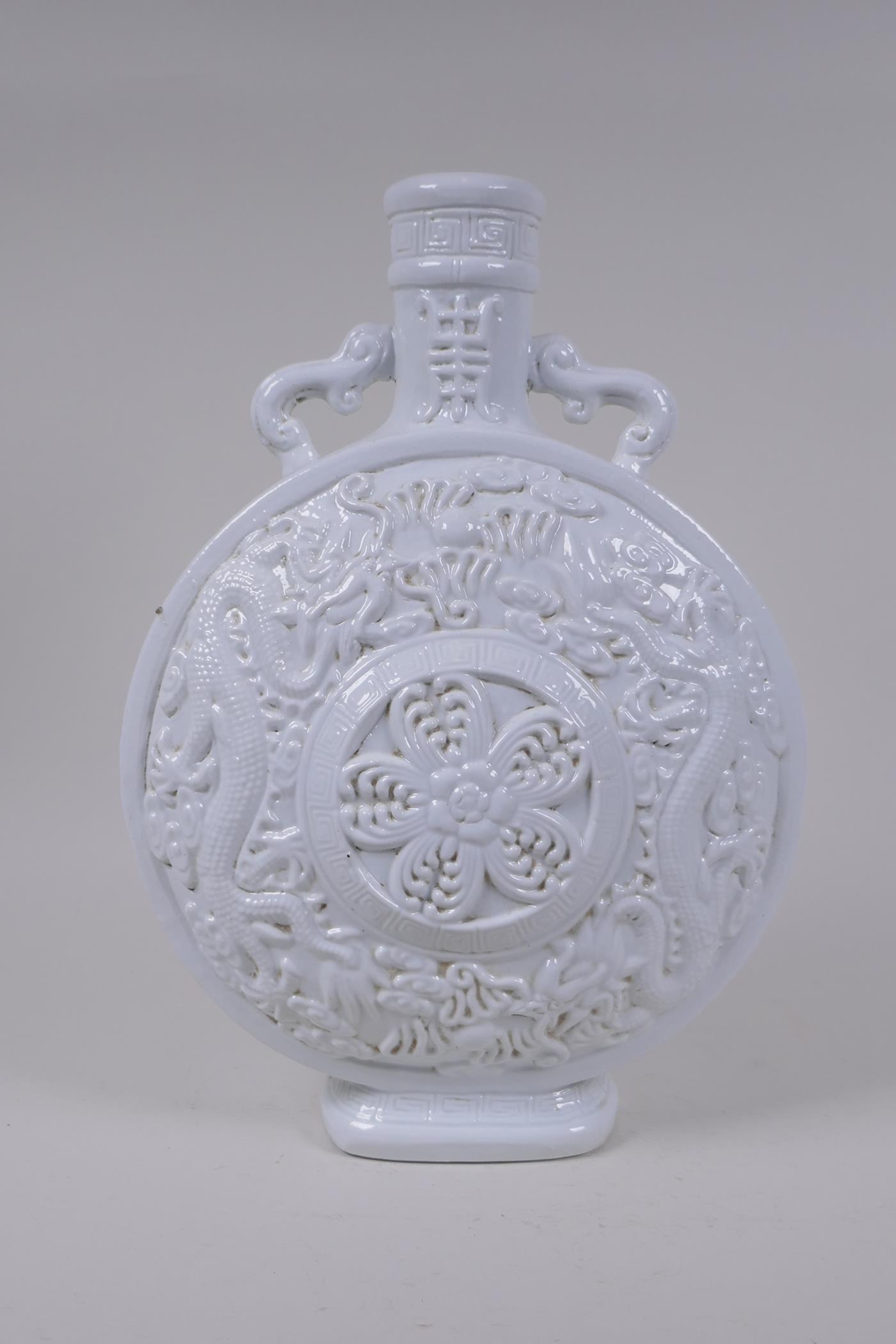 A Chinese blanc de chine porcelain two handled moon flask with raised and floral decoration, - Image 4 of 6