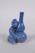 A Chinese blue glazed porcelain stem vase in the form of a seated figure holding a double gourd, 6cm