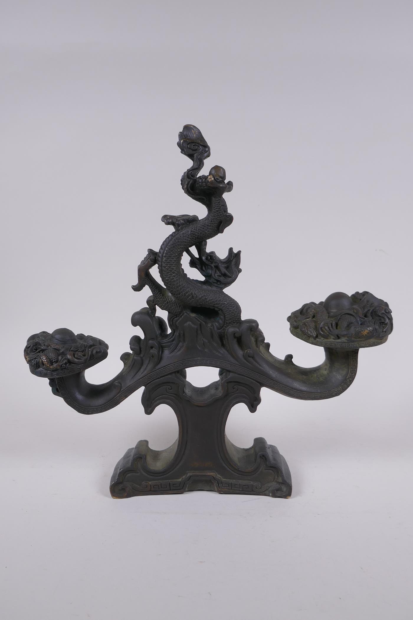 A Chinese filled bronze ornament in the form of a ruyi surmounted by a dragon with a character - Image 3 of 8