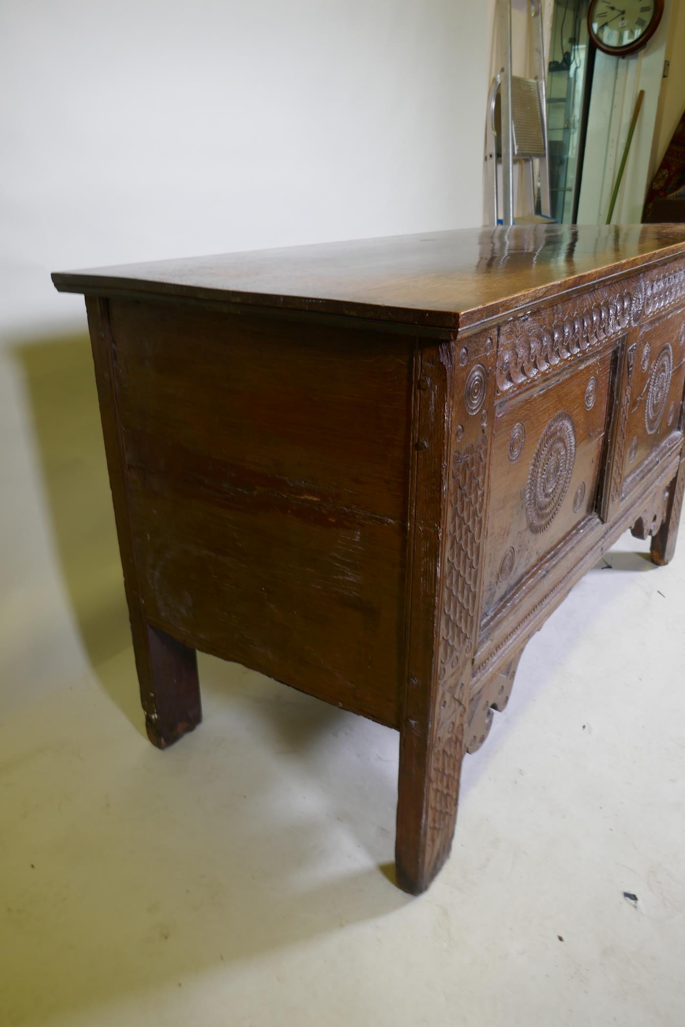 An C18th continental oak coffer, two panelled front with chip carved decoration under a sea scroll - Image 5 of 5