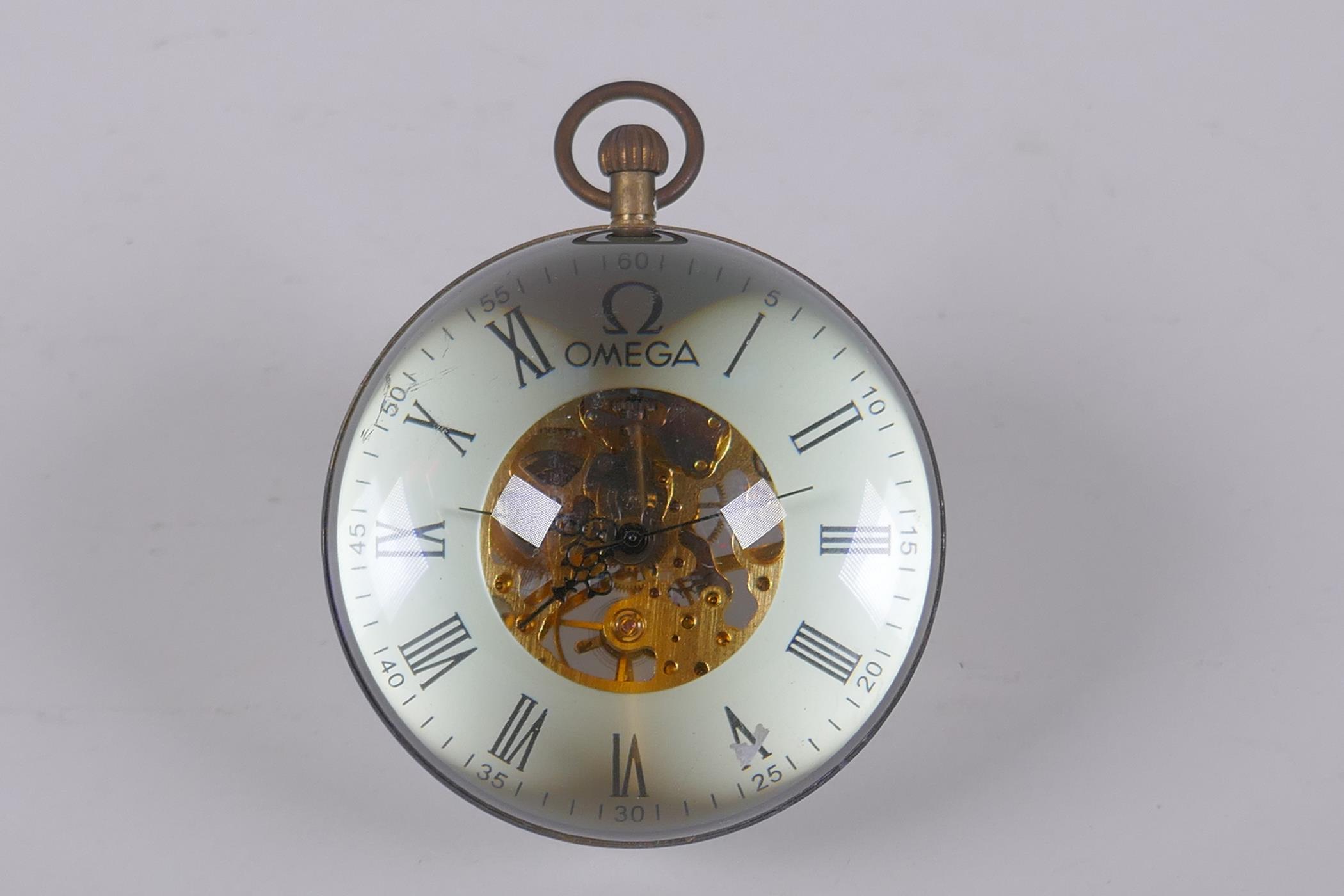 A brass and glass ball desk clock, 8cm diameter