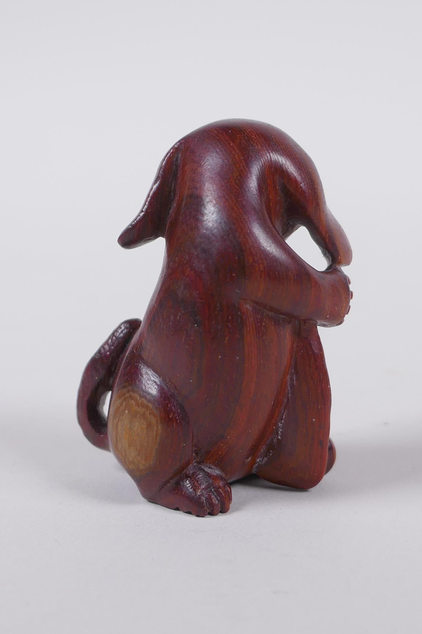 A Japanese carved wood netsuke in the form of a dog, signed, 5cm high - Image 2 of 3