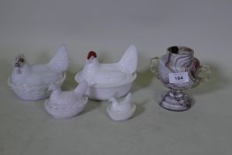 Three Victorian slag glass egg crocks in the form of a hen on a basket, largest 12cm long