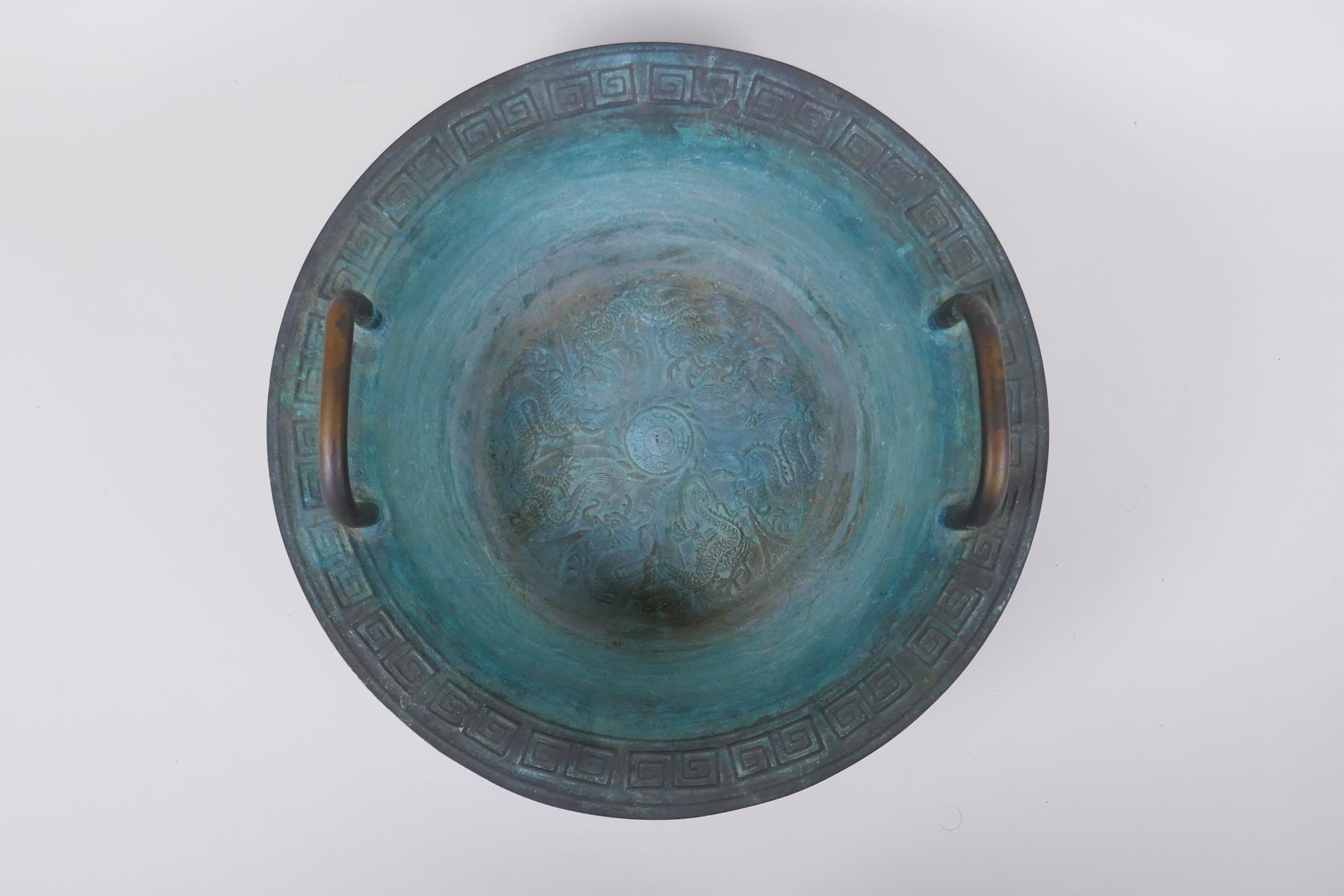 An antique Chinese bronze two handled spouting bowl with dragon decoration, 30cm diameter - Image 2 of 5