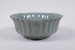 A Chinese celadon crackle glazed porcelain bowl of ribbed form, with flared rim, AF chip to rim,