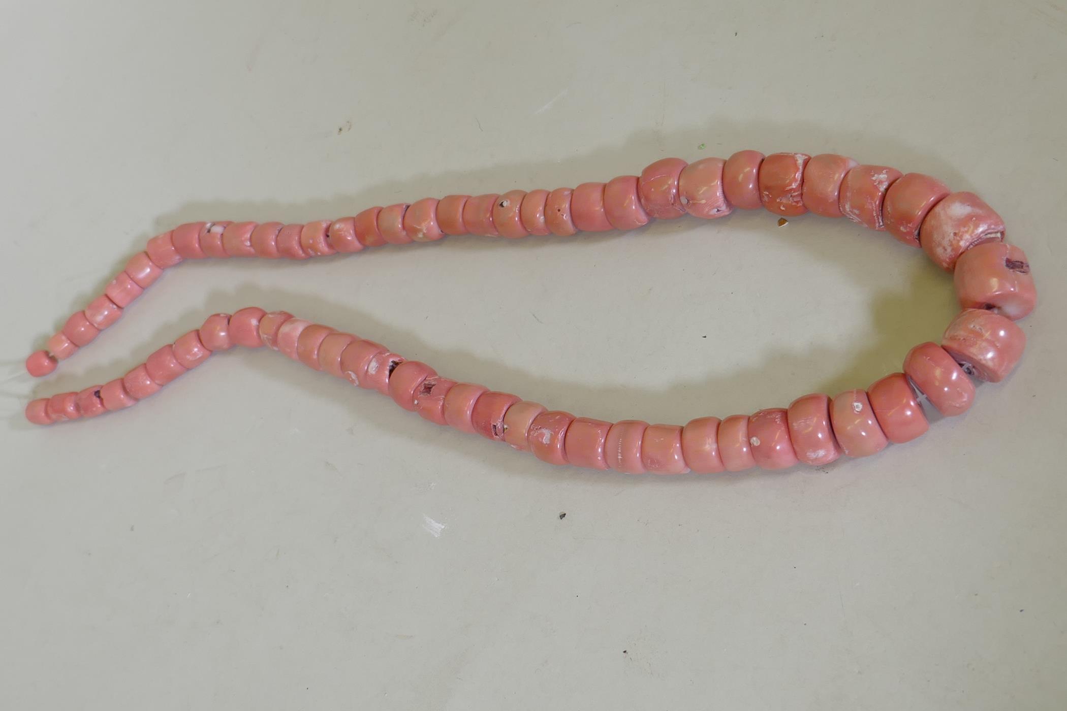 A graduated coral bead necklace, largest bead 2 x 2.5cm