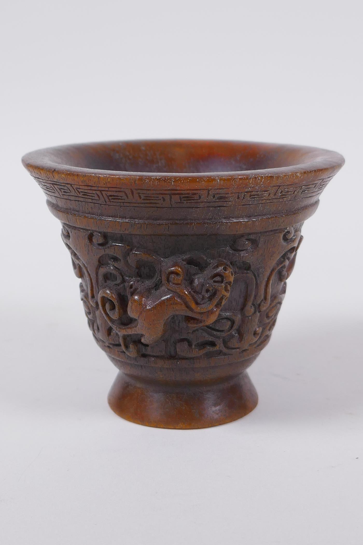 A Chinese faux horn libation cup with raised kylin decoration, seal mark to base, 8cm high x 10cm - Image 2 of 6