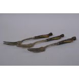 Three Middle Eastern horn handled forks in the form of phoenix, with brass, mother of pearl and