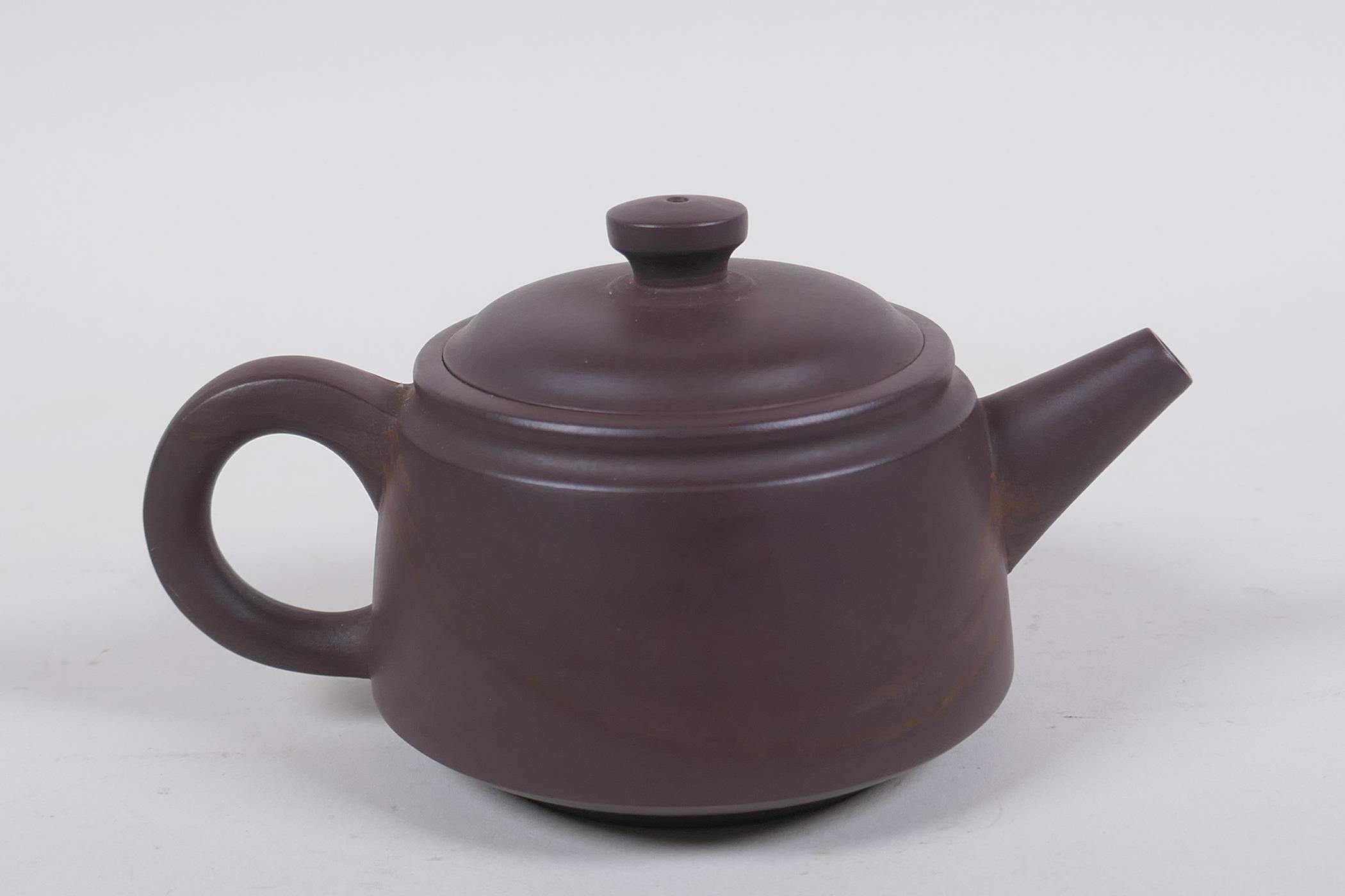 A Chinese YiXing pottery teapot decorated with a character inscription to side, impressed marks to - Image 3 of 5