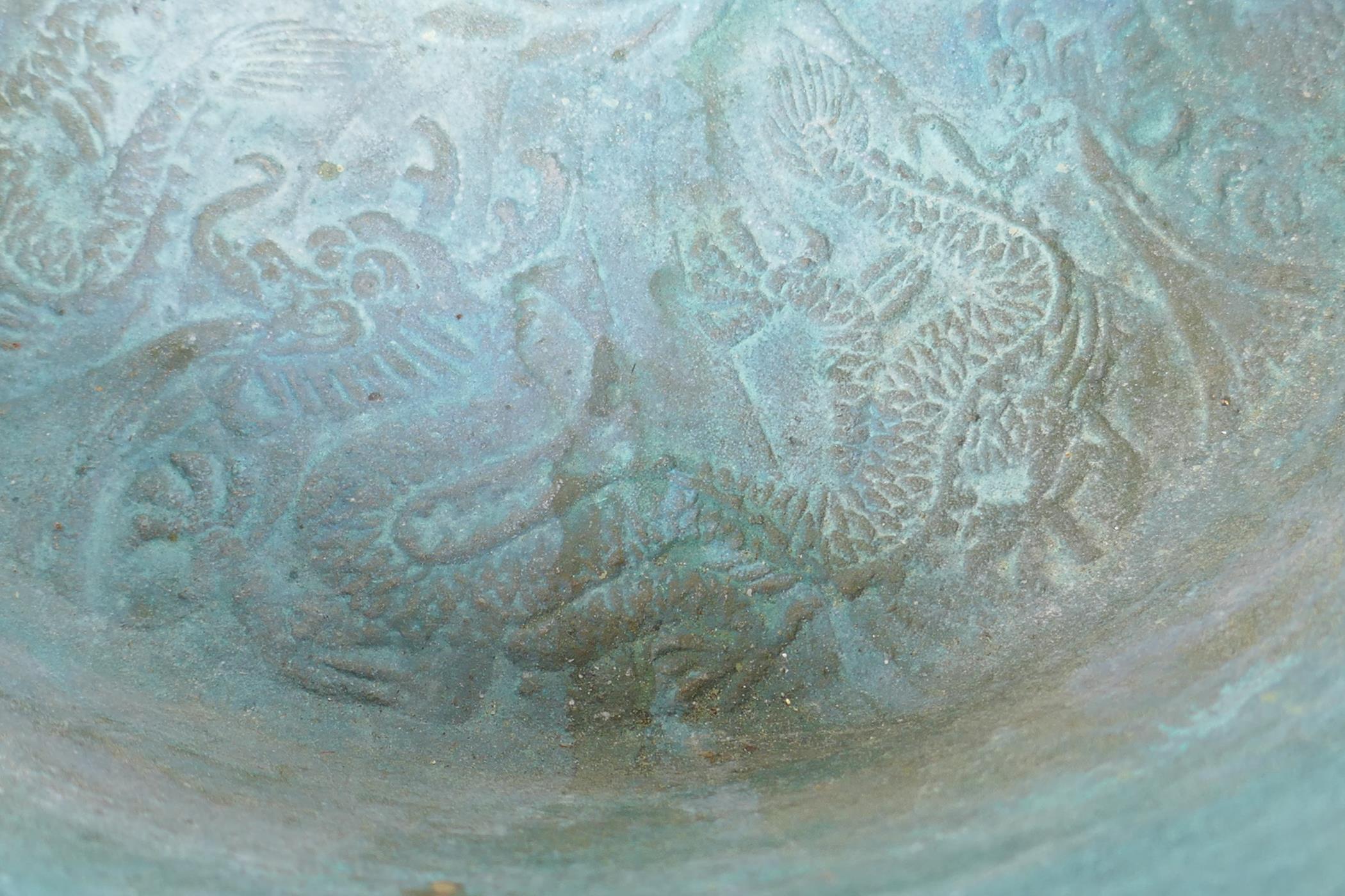 An antique Chinese bronze two handled spouting bowl with dragon decoration, 30cm diameter - Image 4 of 5