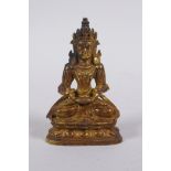 A Sino Tibetan gilt bronze figure of Buddha seated on a lotus throne, 7cm high