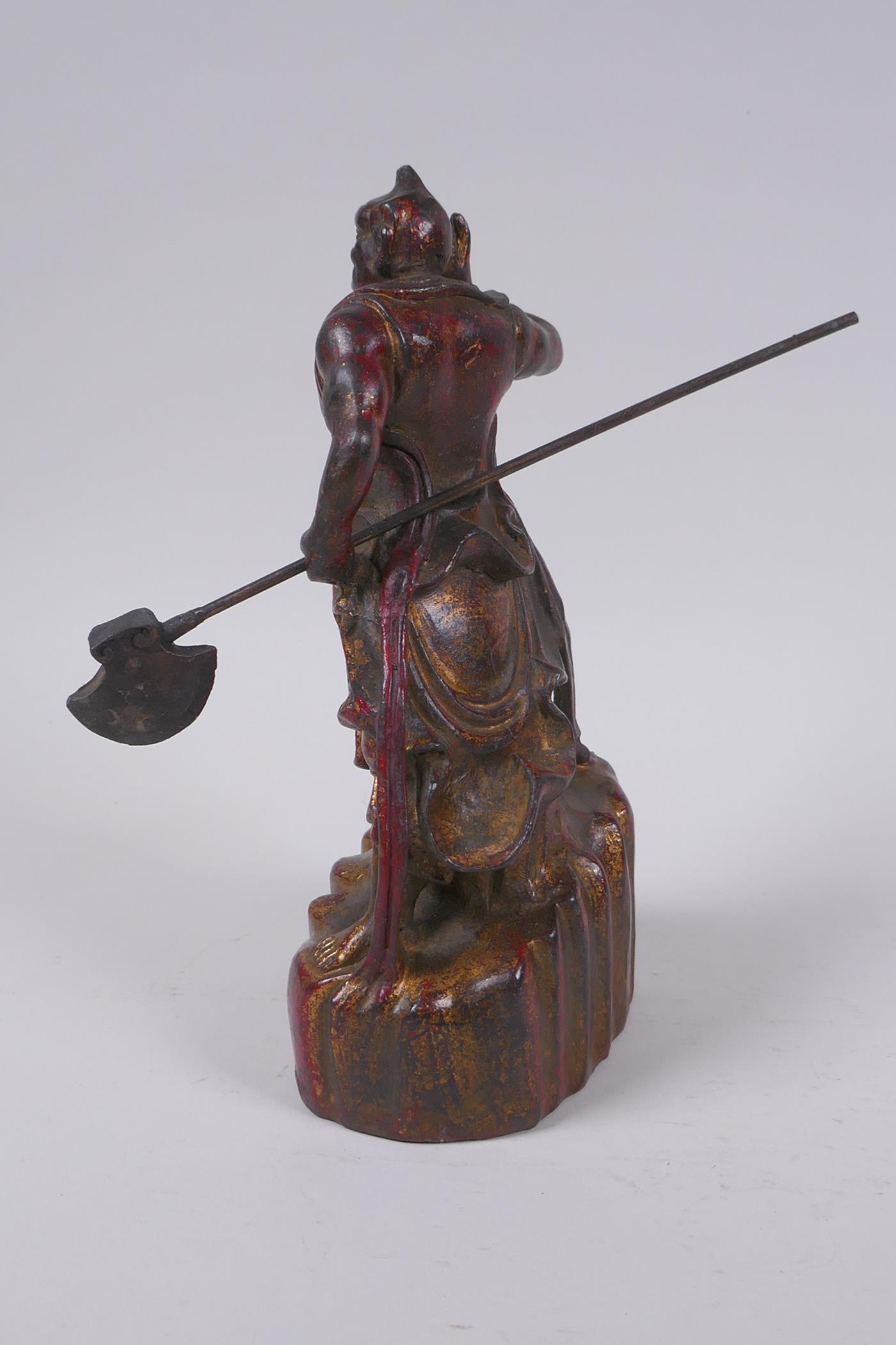 A Sino Tibetan painted and gilt bronze figure of a warrior with an axe, impressed 4 character mark - Image 4 of 5