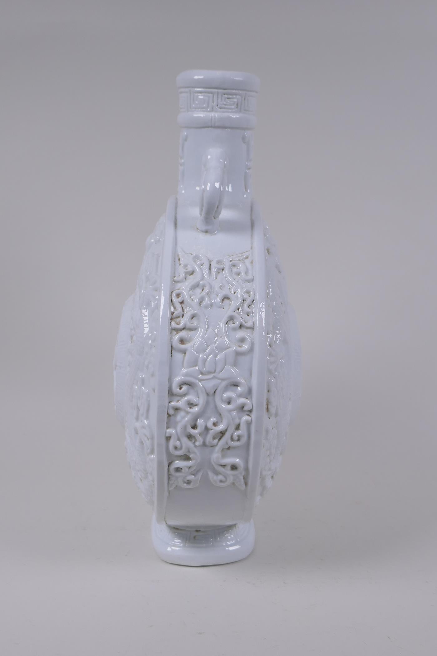 A Chinese blanc de chine porcelain two handled moon flask with raised and floral decoration, - Image 5 of 6