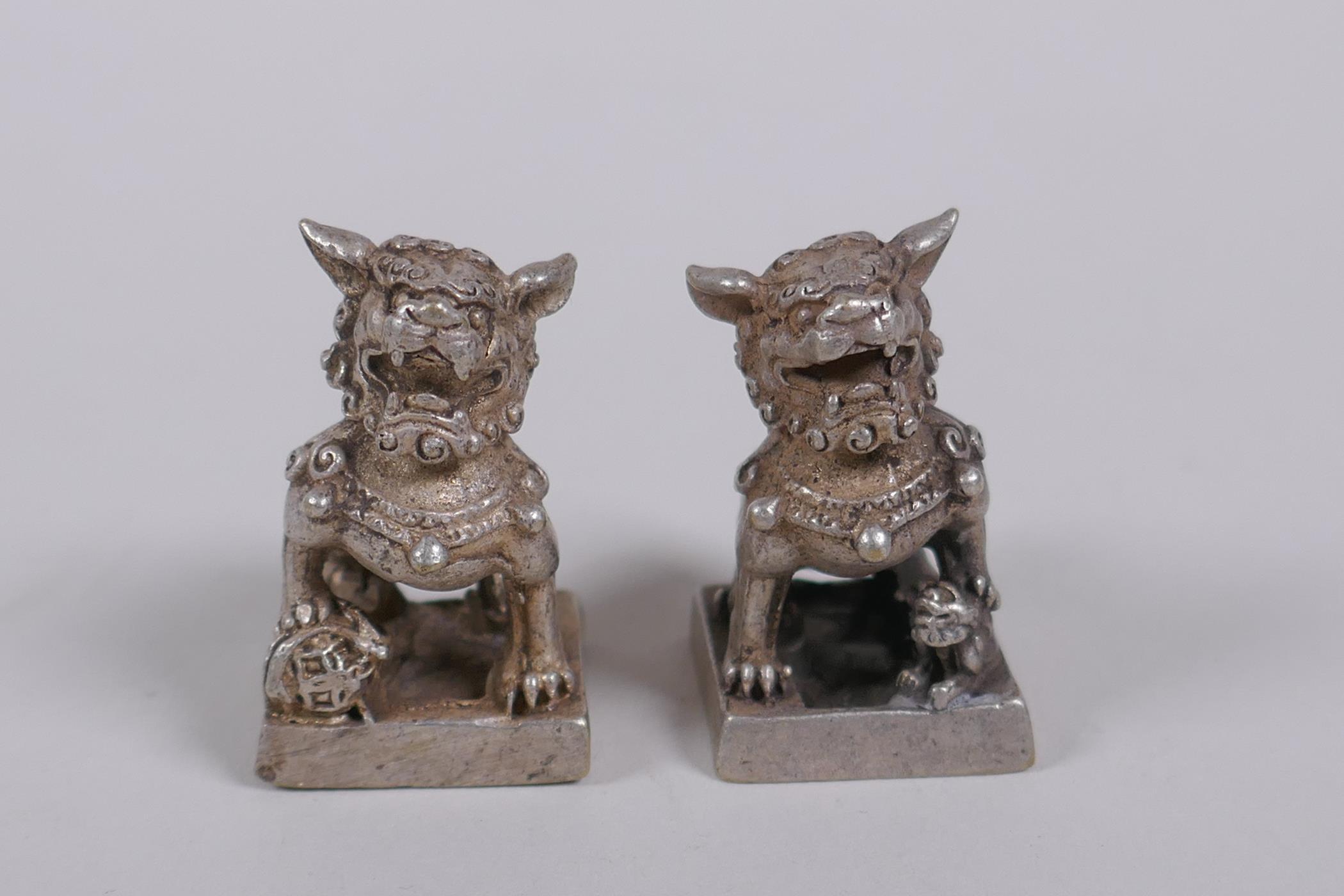 A pair of Chinese white metal seals with Fo dog knops, 3cm high