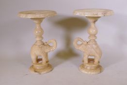 A pair of alabaster side tables in the form of elephants, 38cm diameter, 62cm high