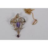 An Art Nouveau style 9ct gold pendant/brooch set with seed pearls and amethyst, 4cm long, and a