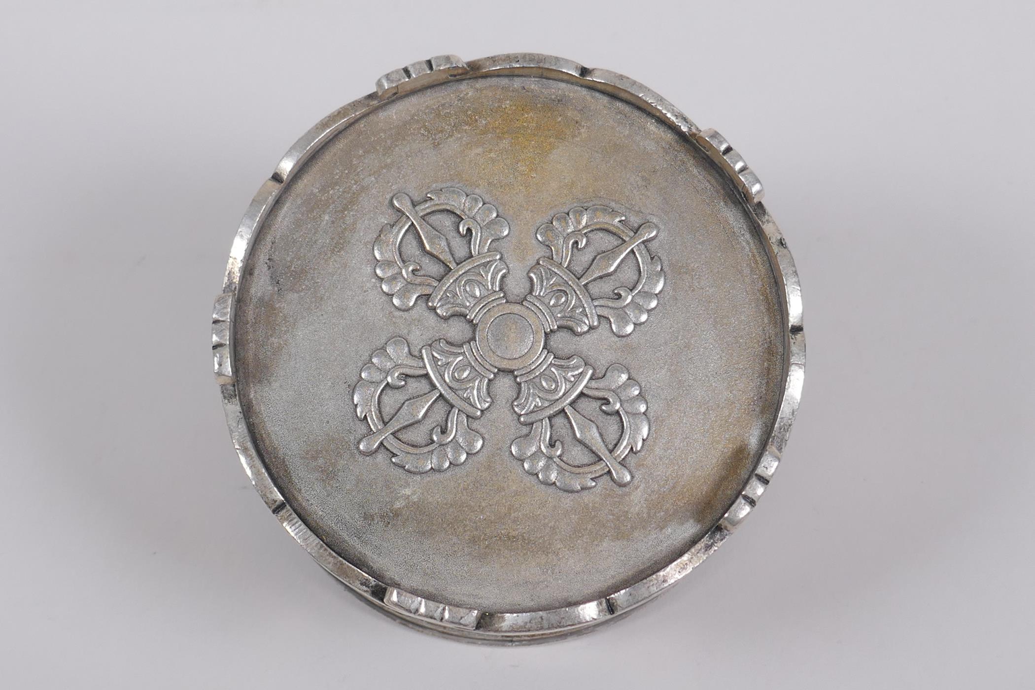 A Sino Tibetan white metal cylinder censer and cover, decorated with the emblems of the eight - Image 6 of 6