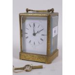 A mid C19th brass cased carriage clock, with engraved decoration, the enamel dial with Roman