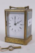 A mid C19th brass cased carriage clock, with engraved decoration, the enamel dial with Roman