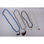 A string of blue and red glass mala beads, a string of tiger's eye mala beads, a string of dried