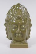 A Chinese olive glazed porcelain headbust of Quan Yin, 26cm high