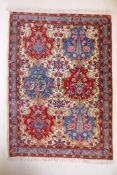 An Iranian cream ground wool rug with blue and red panelled design, 112 x 156cm