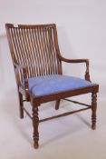 A Liberty & Co, Arts and Crafts  walnut bedroom chair with slat back and reeded frieze, raised on