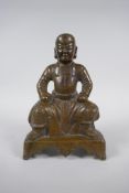 An oriental bronze figure of a seated deity, 21cm high