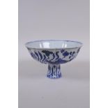 A blue and white porcelain stem bowl of lobed form, decorated with carp in a lotus pond, Chinese