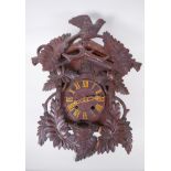 An antique carved Black Forest cuckoo clock, bellows intact, AF, 33 x 42cm