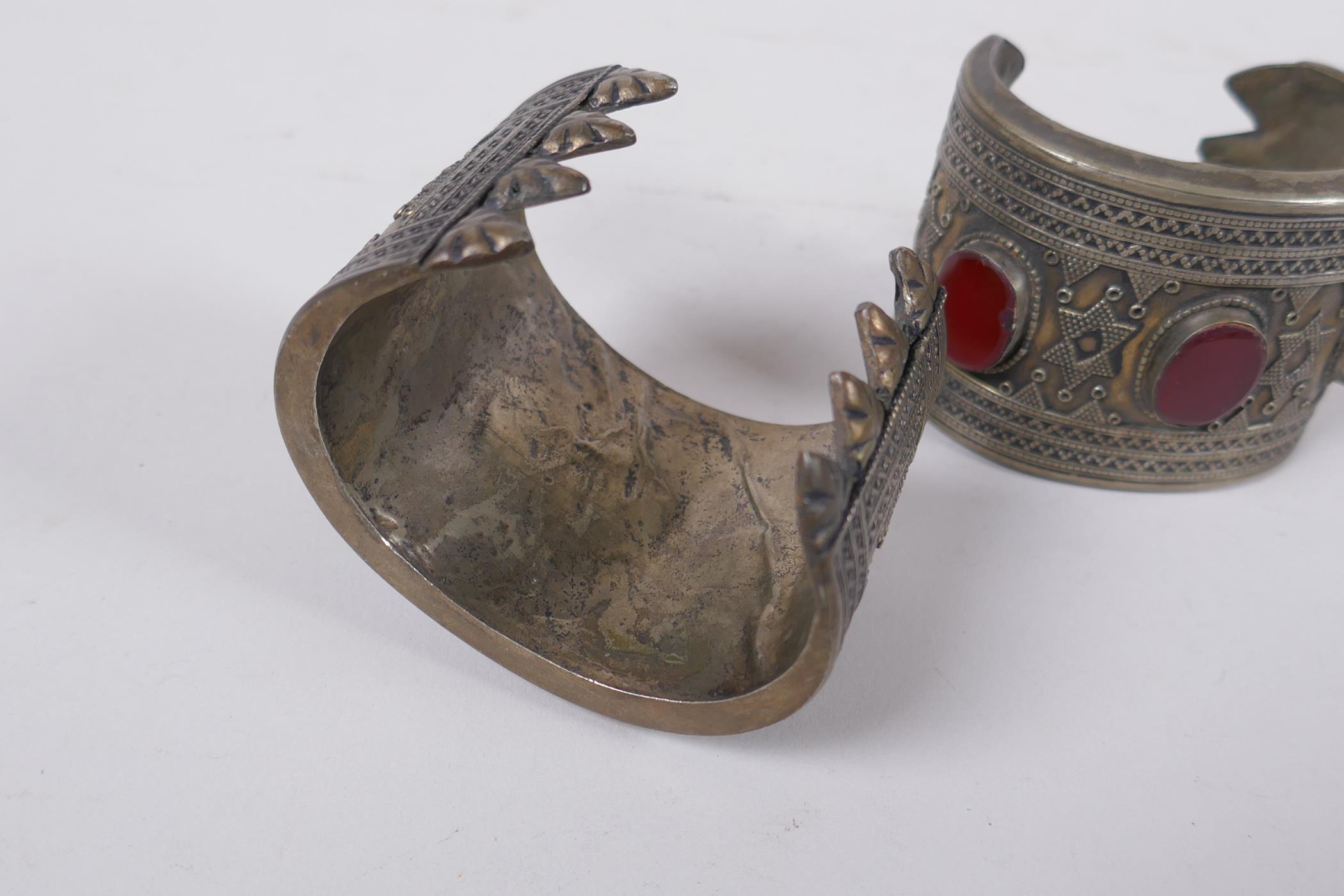 A pair of Turkmen white metal bangles set with red semi precious stones, 8 x 6cm - Image 3 of 3