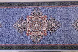 An Iranian fine woven blue ground runner with a medallion design surrounded by an embossed all