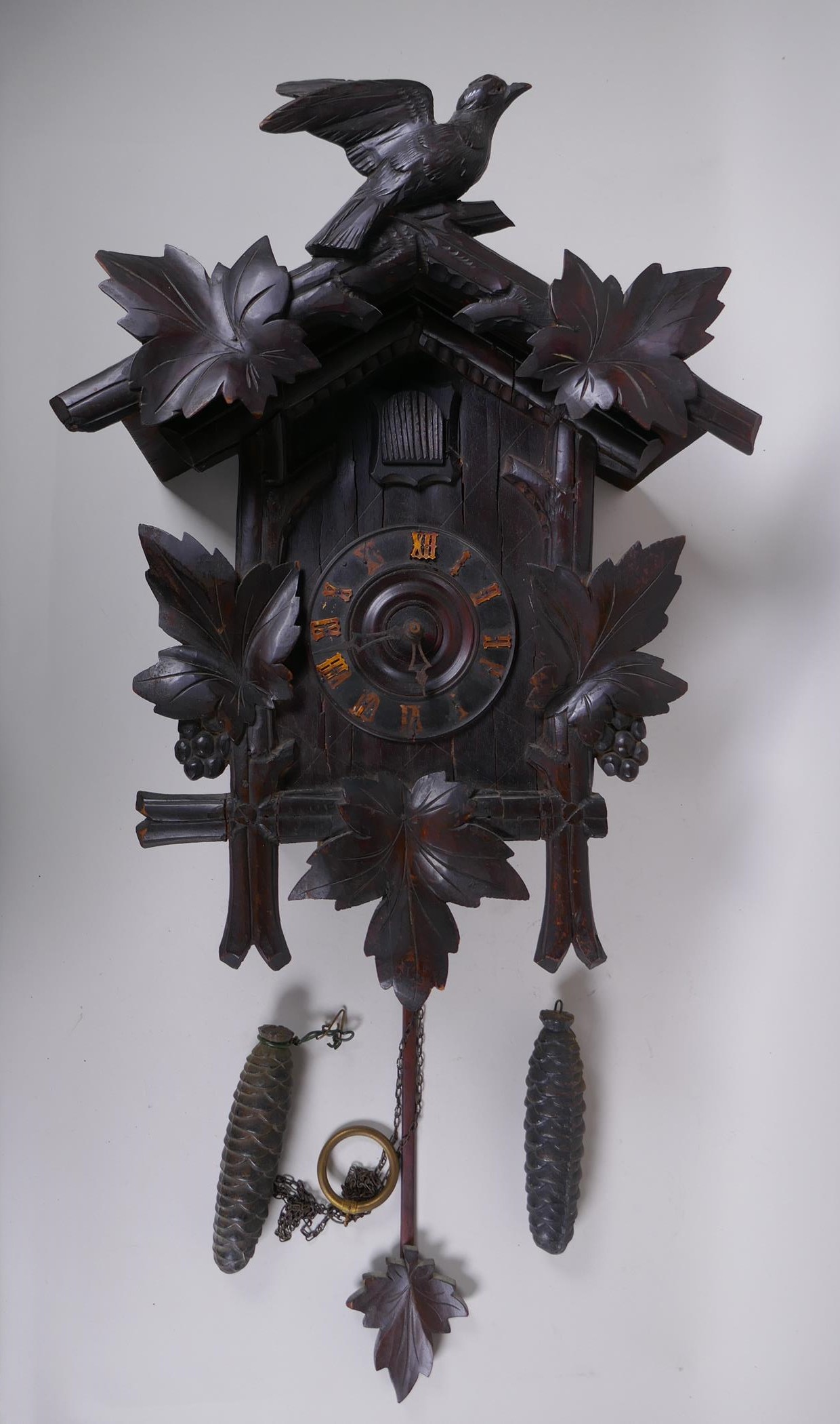 An antique carved Black Forest cuckoo clock, bellows intact, 36 x 56cm
