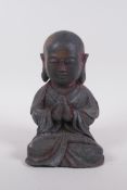 A Chinese bronze figure of Buddha seated in prayer, 19cm high