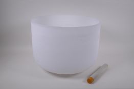 A large crystal singing bowl with sand blasted exterior and polished interior, with fabric wrapped