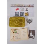 A WWI Queen Mary Christmas 1914 gift tin, with contents, cigarettes unopened, tobacco package (
