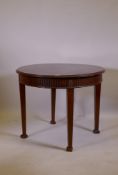 An Adam style mahogany centre table, with fluted frieze and patarae  decoration, raised on square