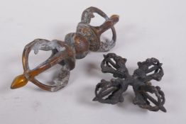 A Tibetan bronze double vajra, together with a larger vajra, 16cm long