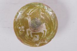 A small middle eastern terracotta bowl with painted deer decoration, 11cm diameter