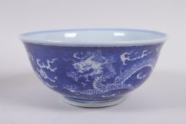 A Chinese blue and white porcelain rice bowl with dragon decoration, Kangxi 6 character mark to