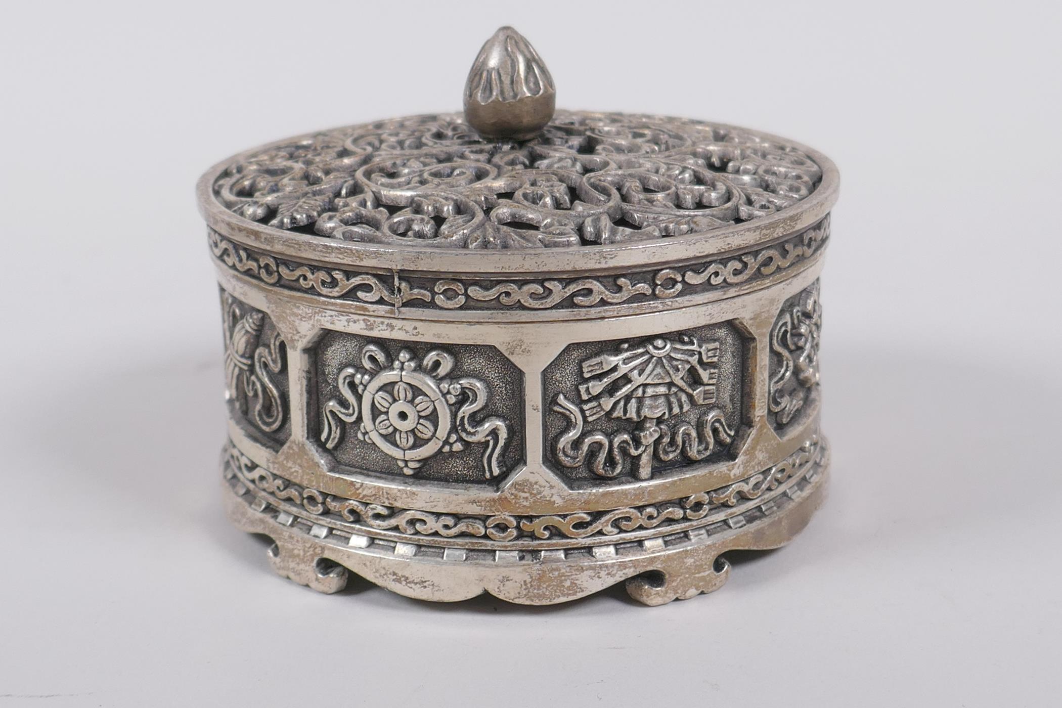 A Sino Tibetan white metal cylinder censer and cover, decorated with the emblems of the eight - Image 3 of 6