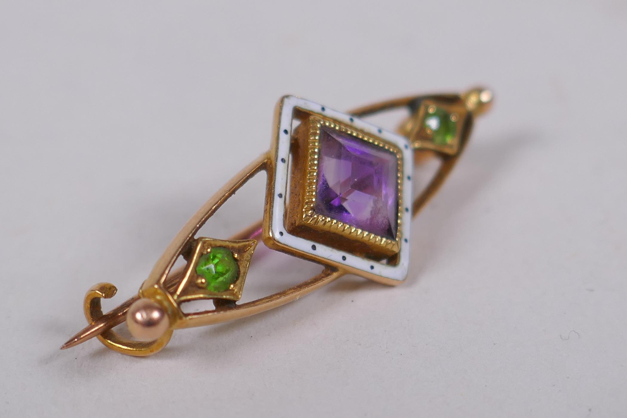 A 15ct gold suffragette brooch set with an amethyst and peridot, and enamel decoration, 3cm long, 3g - Image 2 of 4