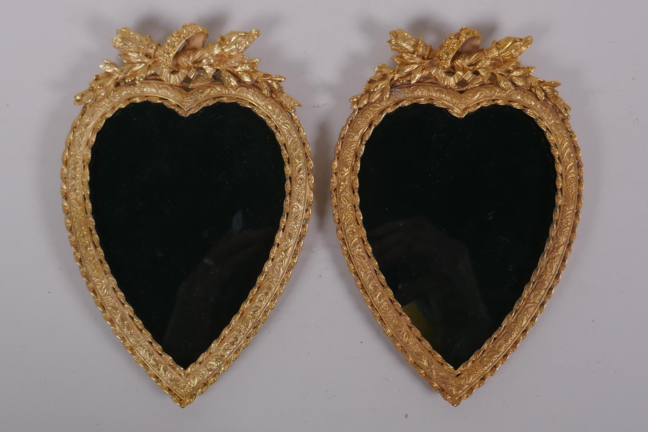 A pair of ormolu heart shaped photograph frames, 13 x 19cm