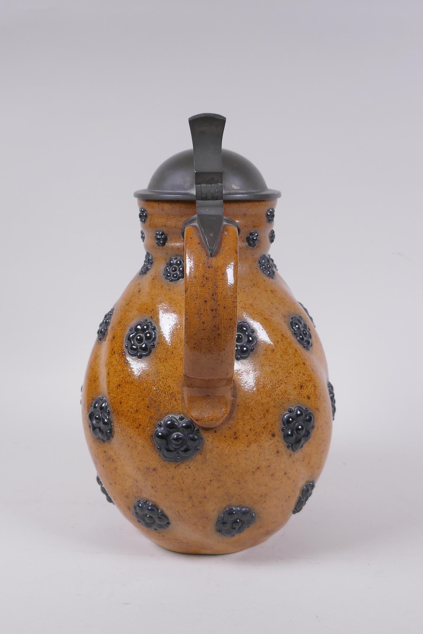 A German Reinheart Merkelbach stoneware art pottery pitcher of swirled form with applied floral - Image 5 of 8