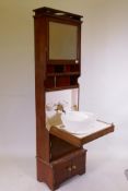 A mahogany ship's cabin wash stand cabinet, the reservoir behind the mirror, with fall front and