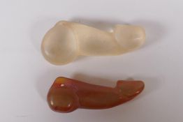 A carved agate phallic pendant and another, 8cm long