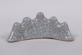 A Chinese celadon crackle glazed porcelain brush rest, 12cm wide