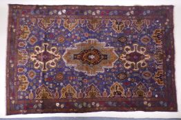 A hand woven blue ground wool Persian Belouch nomadic rug, 190 x 120cm