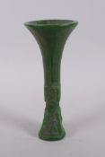 A Chinese reconstituted green hardstone gu shaped vase with archaic decoration, 21cm high